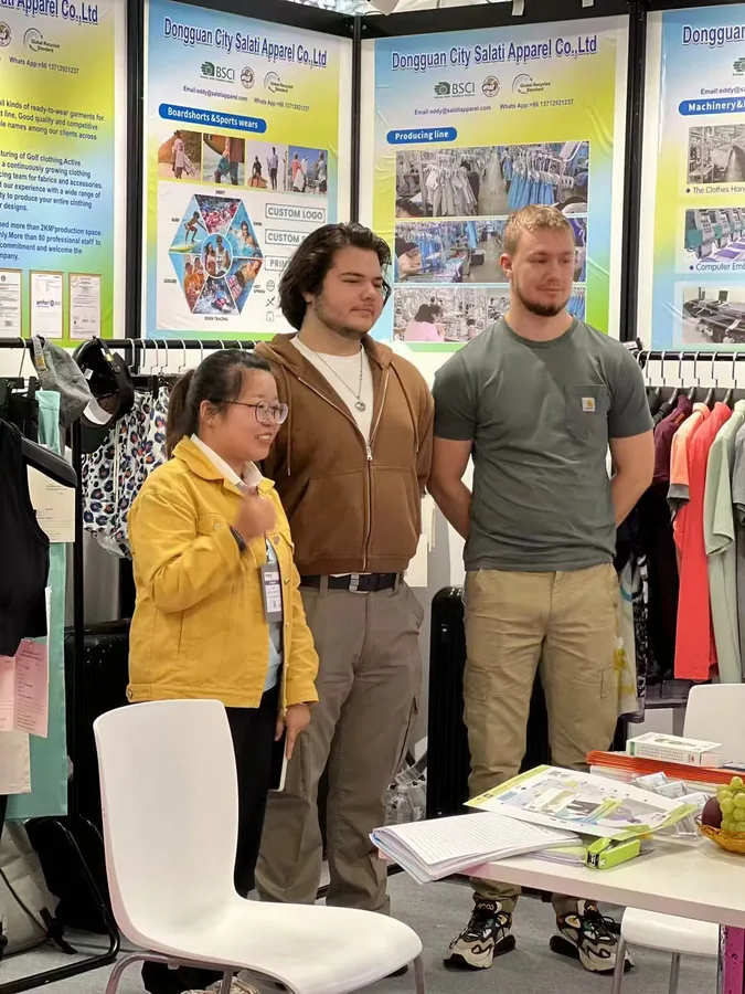 SALATI team members and visitors posing in front of the exhibition display