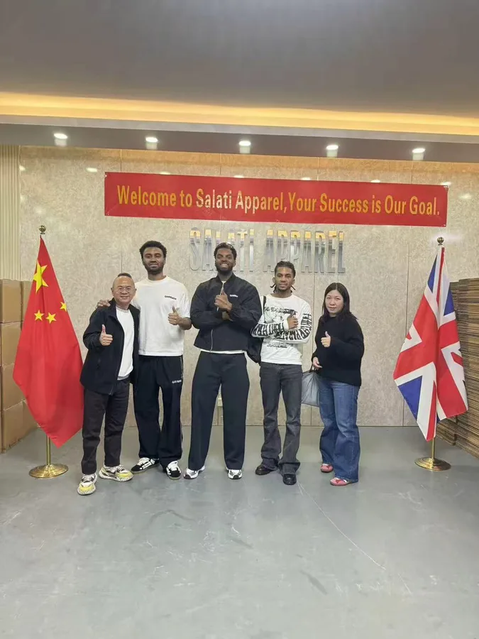 A small group of visitors and SALATI team members posing at the company