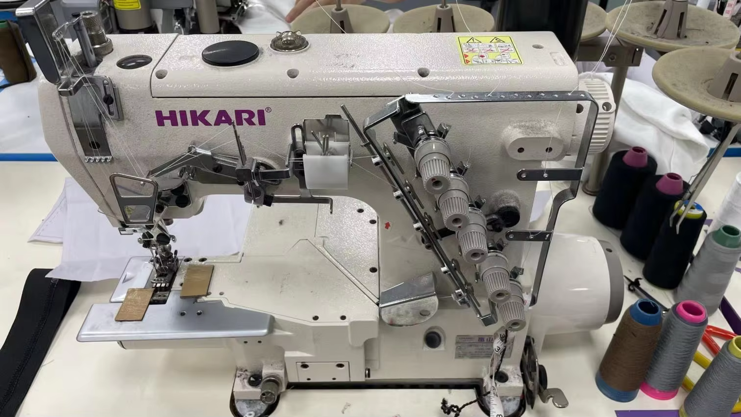 Industrial interlock sewing machine at a SALATI worktable