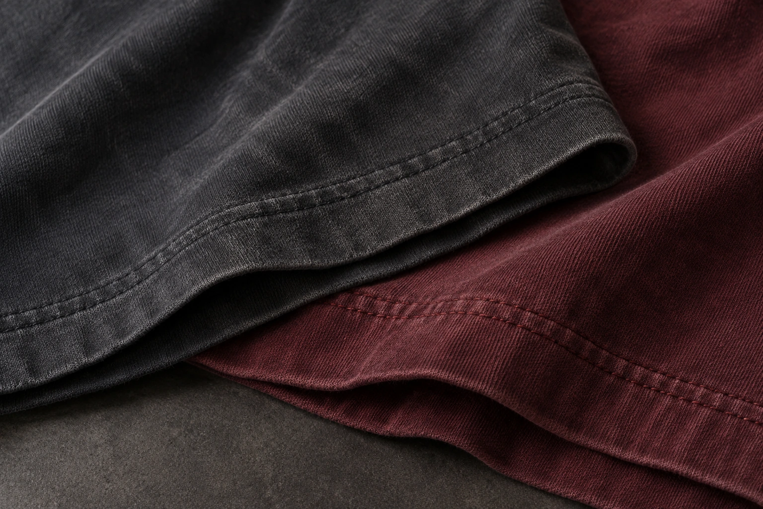 washed charcoal and burgundy cotton jersey hems with subtle pigment fading and double-needle stitching