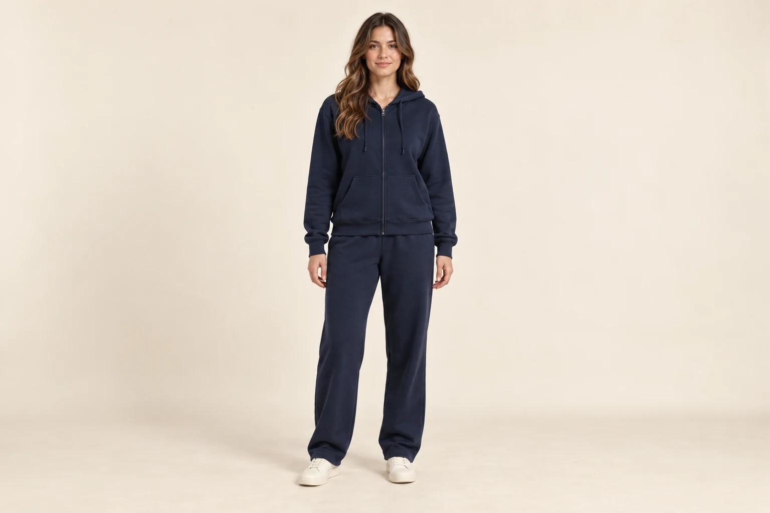 a full-length model wearing a coordinated navy zip hoodie and relaxed trousers